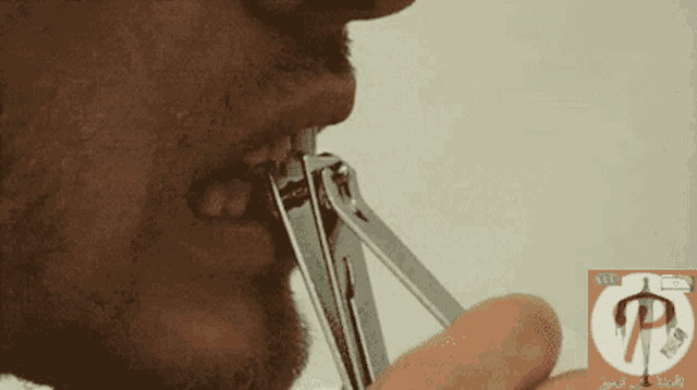 a man is cutting his nails with a pair of scissors