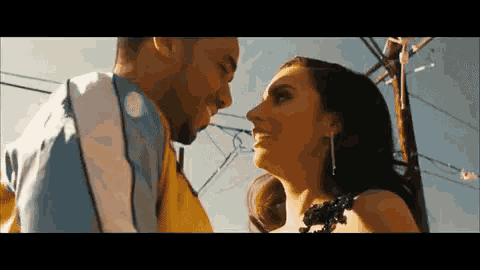 a man and a woman are looking at each other .