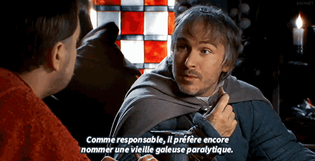 a man in a cape is talking to another man in front of a stained glass window with the caption comme responsable
