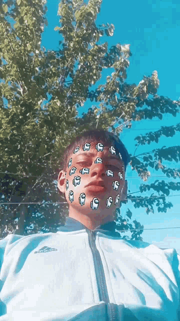 a boy with among us face paint on his face