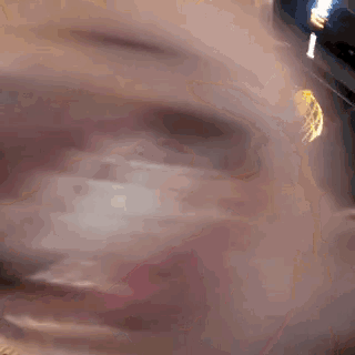 a close up of a baby 's face with a lamp in the background .