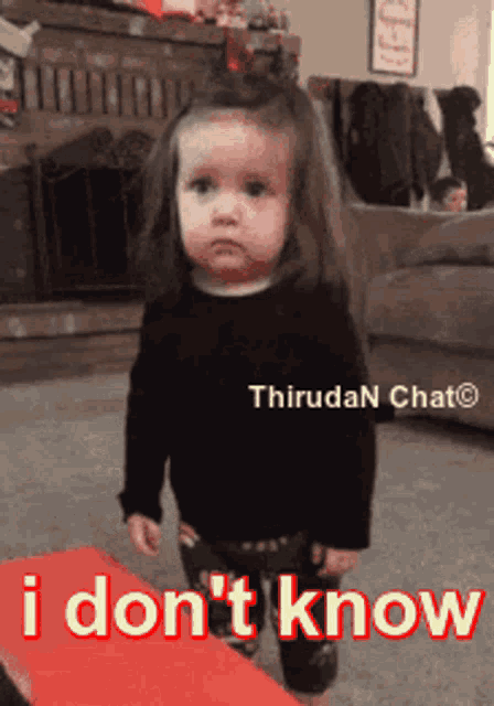 a little girl is standing in front of a sign that says i don t know