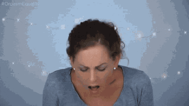 a woman is making a funny face in front of a string of lights and the hashtag #orgasmequality