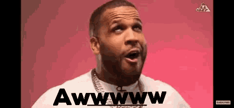 a man with a beard is making a funny face while wearing a chain around his neck .