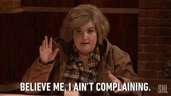 a woman in a brown jacket says believe me i ain 't complaining snl