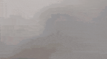 a blurry picture of a person standing in front of a wall .