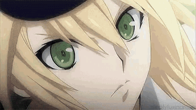 a close up of a person with blonde hair and green eyes .
