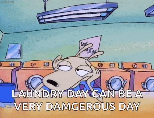 a cartoon character is sitting in a laundromat holding a piece of paper and a sign that says laundry day