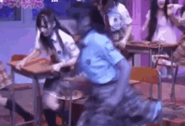 a group of girls are dancing in a classroom .