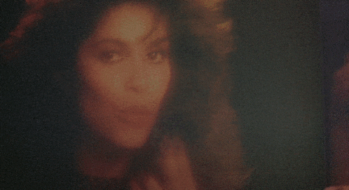 a woman 's face is partially obscured by a blurred background