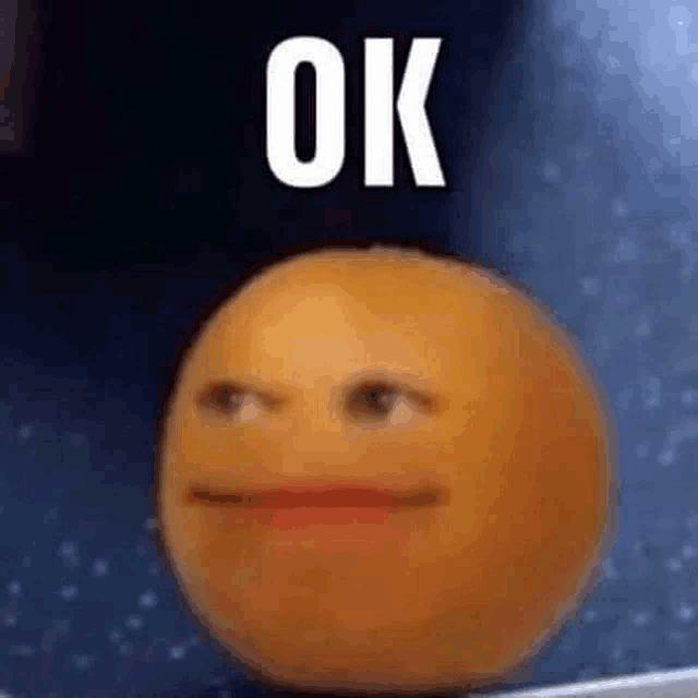 a close up of an orange with a face on it and the words `` ok '' .