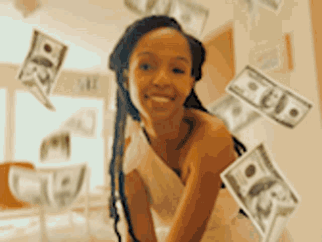 a woman in a white dress is surrounded by money falling from the ceiling .