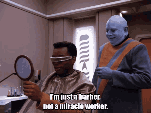 a man in a barber chair looking at himself in a mirror