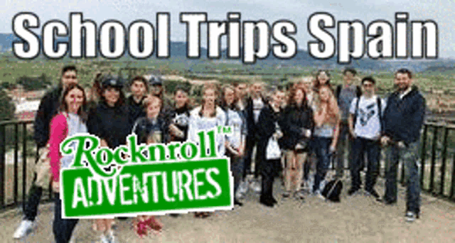 a group of people are standing in front of a sign that says `` school trips spain '' .