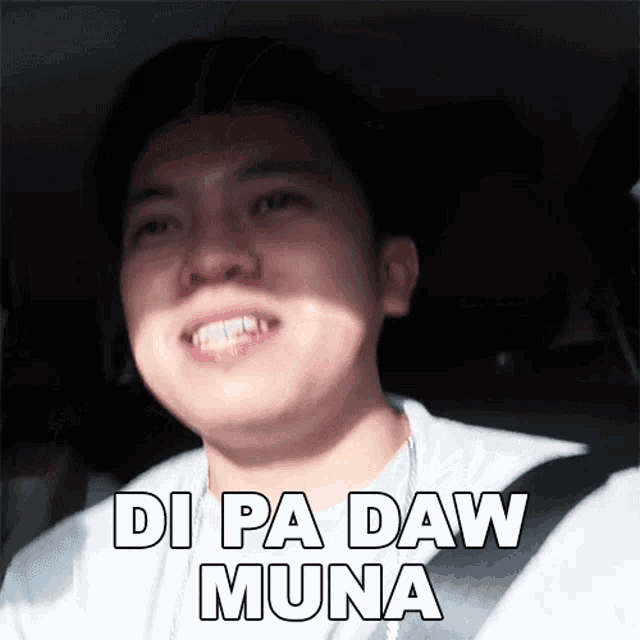 a man in a car with the words di pa daw muna written on his face .