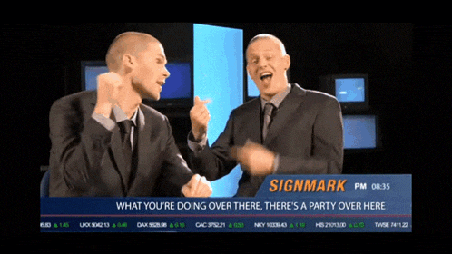 two men are dancing in front of a signmark screen