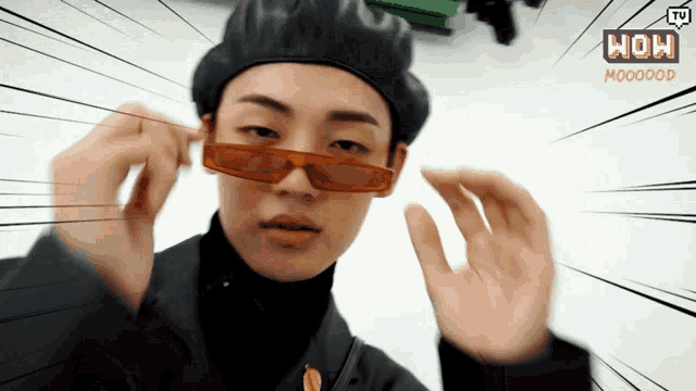 a man wearing sunglasses and a beret with the words wow written on the bottom