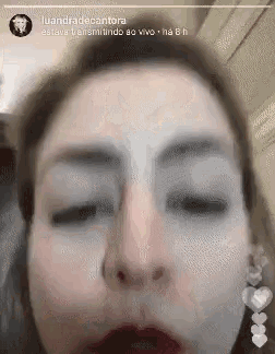 a close up of a woman 's face with her eyes closed and mouth open .