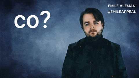 a man with a beard stands in front of a blue background with the words co written on it