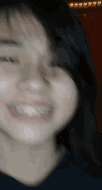 a close up of a woman 's face smiling