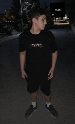 a young man wearing a black shirt that says rash on it