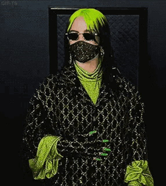 billie eilish wearing a mask and sunglasses at the grammy awards .