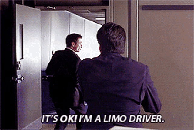 a man in a suit says it 's ok i 'm a limo driver in front of another man