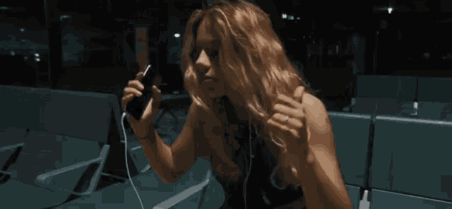a woman in a black bra is giving a thumbs up .