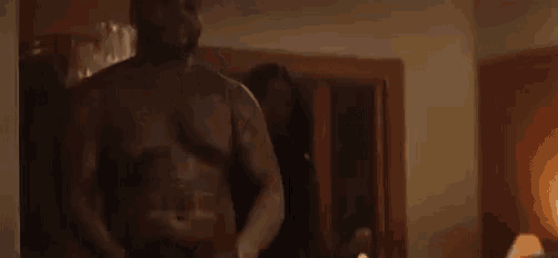 a man is standing next to a woman in a dark room .