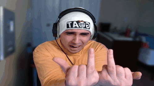 a man wearing headphones and a beanie that says taco on it