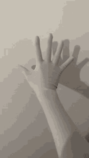 a person is wearing a white glove and making a hand gesture .