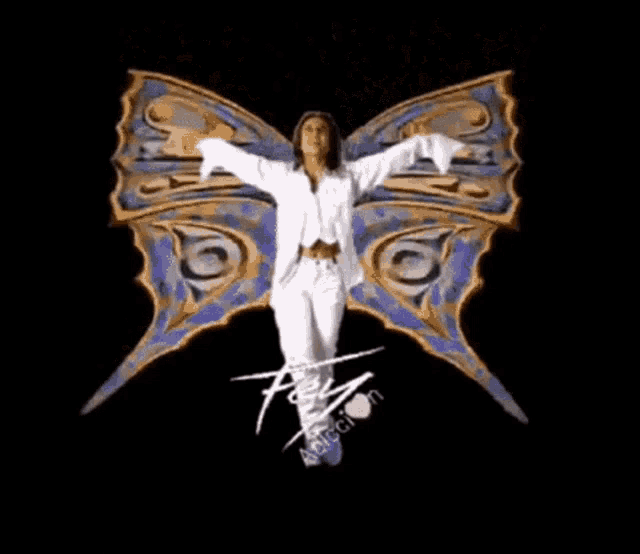 a woman in a white suit stands in front of a butterfly with the letters f and t on it
