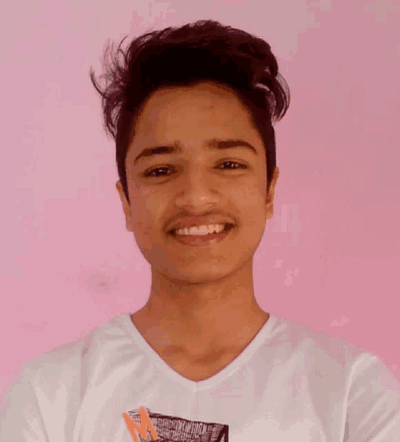 a young man wearing a white t-shirt with a pencil in his pocket