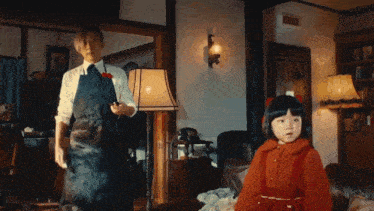 a man in an apron is standing next to a little girl