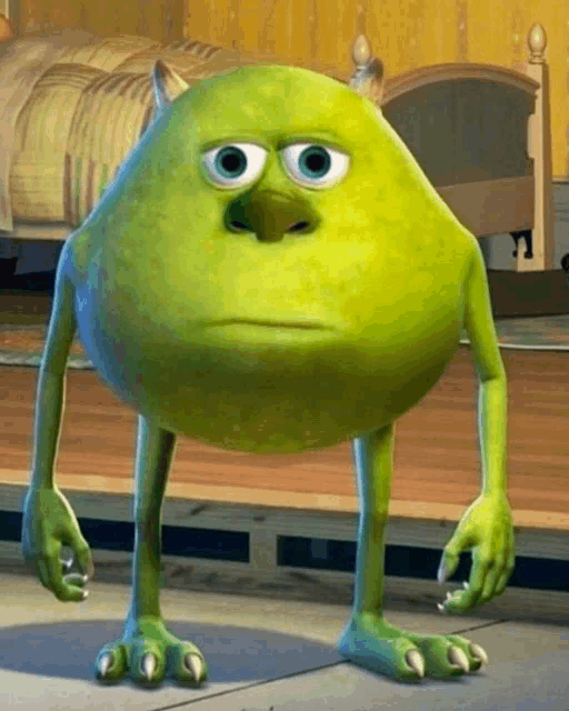 mike wazowski from monsters inc is standing on the floor with a sad look on his face
