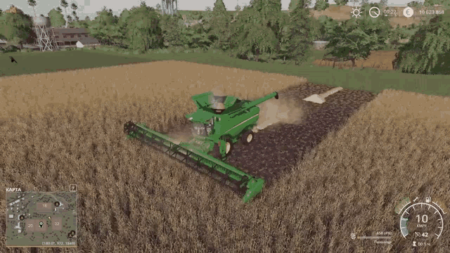 a green john deere combine harvester is cutting a field of wheat
