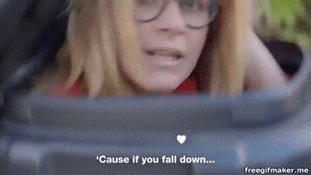a woman wearing glasses is sitting in a car and says cause if you fall down