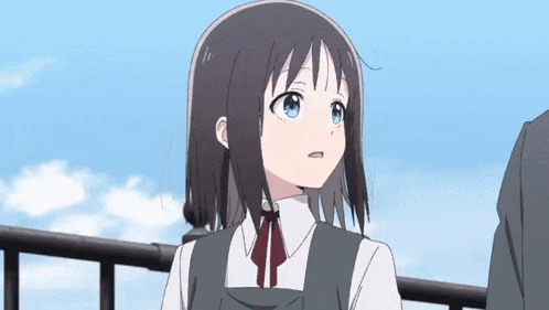 a girl in a school uniform is standing next to a man on a balcony looking up at the sky .