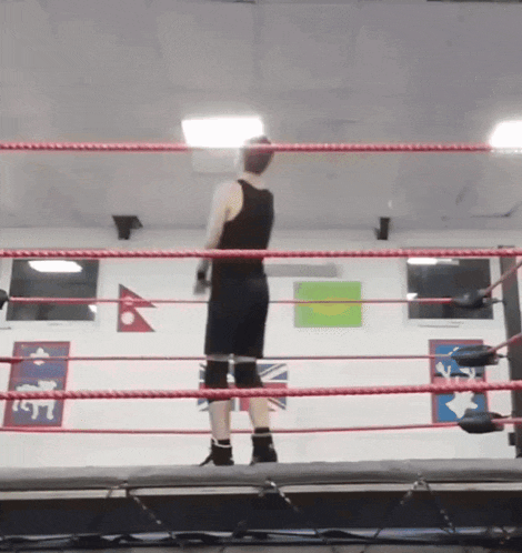 a person standing in a boxing ring with a sign on the wall that says ' lsst '