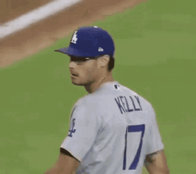 a baseball player wearing a number 17 jersey is standing on a baseball field .