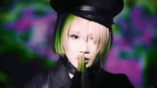 a woman with green hair is wearing a hat and gloves