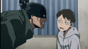 a man in a mask is talking to a boy who is wearing a hoodie that says just