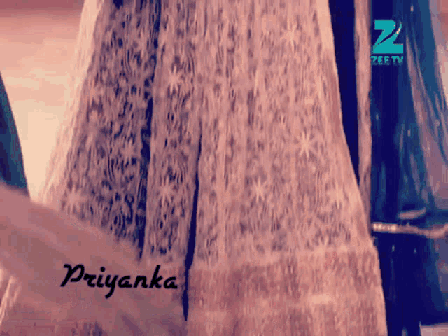a woman in a white dress with the name priyanka on it