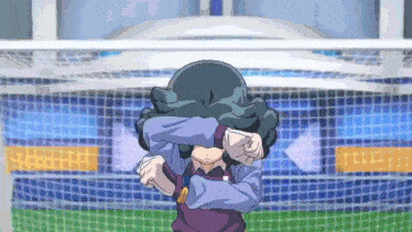 a cartoon character covering his face with his hands in front of a stadium