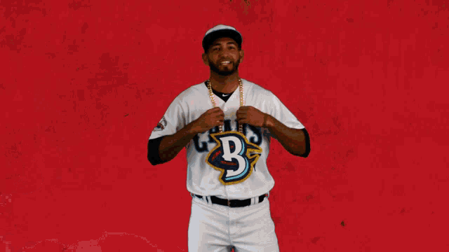 a baseball player wearing a white jersey with the number 37 on it