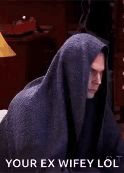 a man is wrapped in a blanket and says `` your ex wifey lol ''