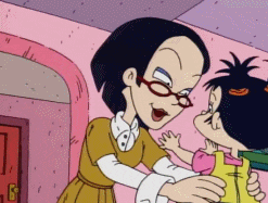 a woman with glasses is holding a little girl