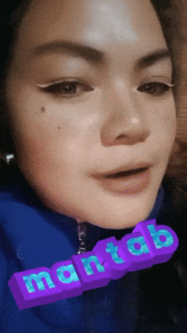 a close up of a woman 's face with the word martab written in purple