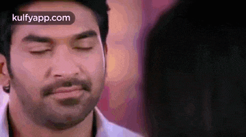 a close up of a man 's face with his eyes closed .