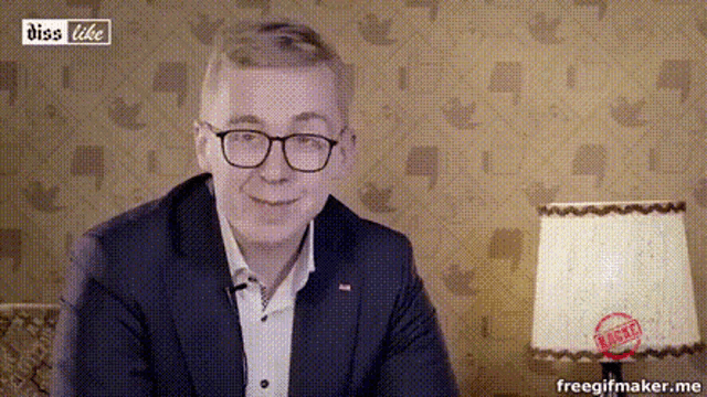 a man wearing glasses and a suit is sitting in front of a lamp that has a stamp that says ' false '